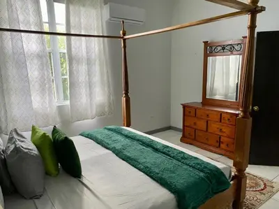 a bedroom with a canopy bed and a dresser at Tranquil Escape at Ballast Bay in Road Town