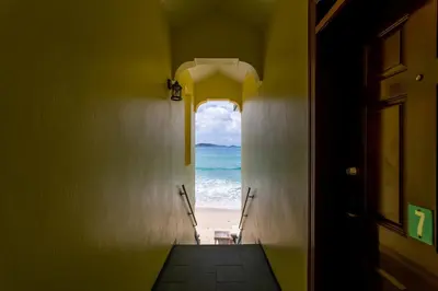 an open door with a view of the beach at Sebastian's on the beach hotel in Road Town