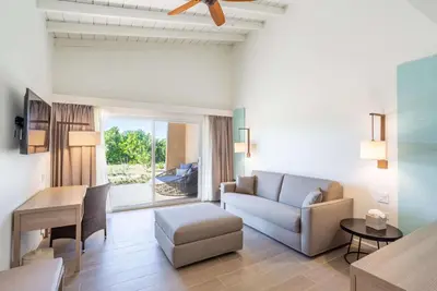 a living room with a couch and a table at Wyndham Tortola BVI Lambert Beach Resort in East End