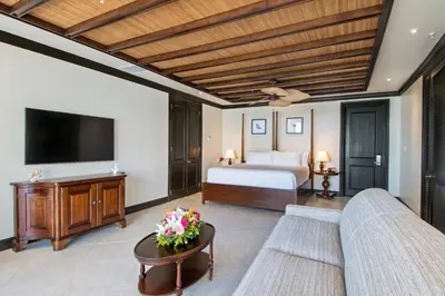 a hotel room with a bed and a tv at Scrub Island Resort, Spa & Marina in The Mill