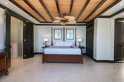 a bedroom with a bed and a ceiling fan at Scrub Island Resort, Spa & Marina in The Mill