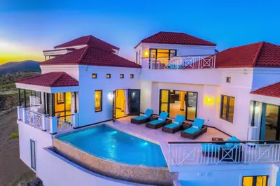 an aerial view of a house with a swimming pool at Scrub Island Resort, Spa & Marina in The Mill