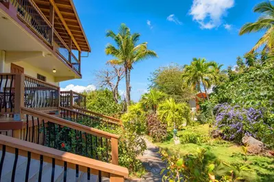 a view of the garden from the balcony of a house at Bayview Vacation Apartments in Virgin Gorda
