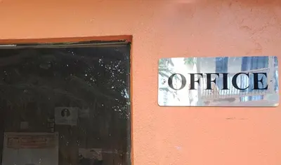 a sign on the side of a building that says office at Bayview Vacation Apartments in Virgin Gorda