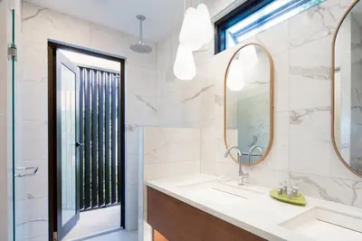 a bathroom with a sink and a mirror at Peter Island Resort in Anderson