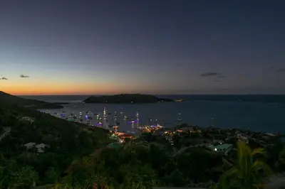 a view of a harbor with boats in the water at night at TAMAR VILLA in Virgin Gorda
