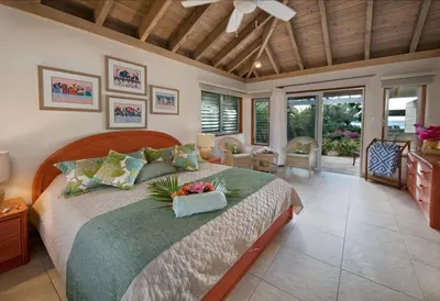 a bedroom with a large bed with flowers on it at BEACHCOMBER VILLA in Virgin Gorda