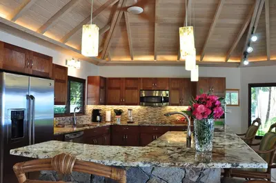 a kitchen with a counter with a vase of flowers on it at CARIBBEAN WIND in Virgin Gorda