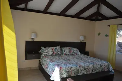a bedroom with a bed and a window and a bed sidx sidx sidx at SERENDIPITY in Virgin Gorda