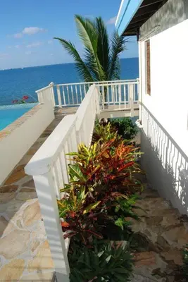 a white staircase leading to a house on the beach at SERENDIPITY in Virgin Gorda