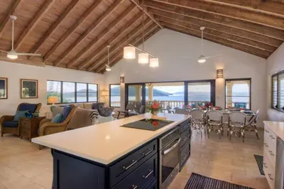 a kitchen and living room with a table and a dining room at A DREAM COME TRUE VILLA in Virgin Gorda