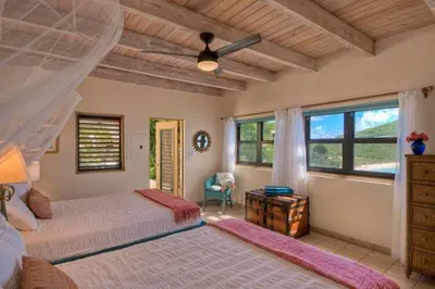 a bedroom with two beds and a ceiling at A DREAM COME TRUE VILLA in Virgin Gorda