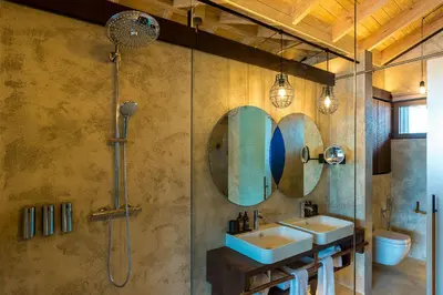 a bathroom with two sinks and a shower at Saba Rock Resort in Virgin Gorda