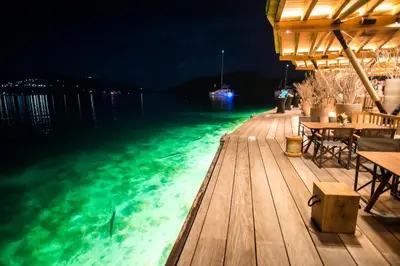a pool of water at night with lights on it at Saba Rock Resort in Virgin Gorda