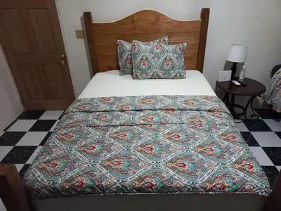 a bed with a quilt on it in a bedroom at More Than Beauty Properties in Tortola Island