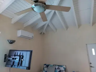 a ceiling fan in a living room with a couch at More Than Beauty Properties in Tortola Island