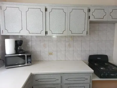a kitchen with a counter top with a microwave at More Than Beauty Properties in Tortola Island