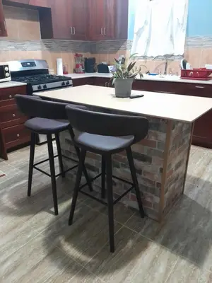 a kitchen island with two chairs and a counter top at Abigail's Spectacular 2 bedrooms-Entire Apartment in Tortola Island