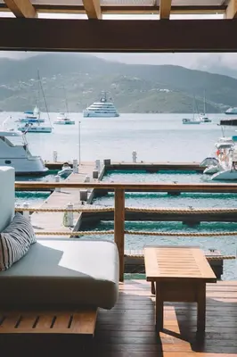 a living room with a view of a harbor with boats at Bitter End Yacht Club in Virgin Gorda