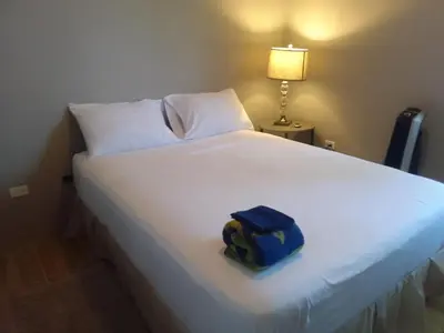 a blue bag sitting on top of a bed at Abigail's Splendor -2 Bedroom Entire Apartment in Tortola Island